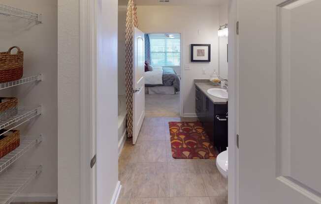 Walk-in closet leading into bathroom; inside main bedroom