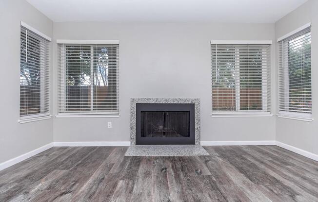 a living room with a fireplace and a large window