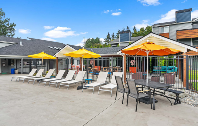 the courtyard at our apartments with tables and chairs and umbrellas