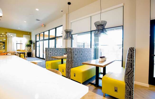 a dining room with yellow chairs and a table