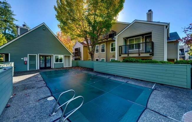 a backyard with a tennis court and a house