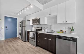 A modern kitchen with dark wood cabinets and stainless steel appliances.