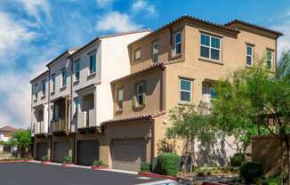 a group of apartment buildings with garages