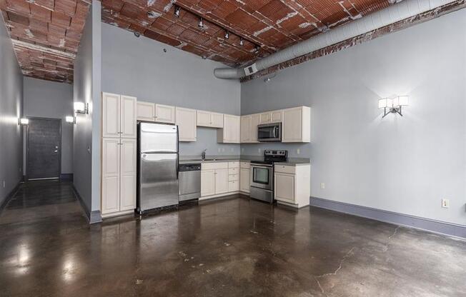 a kitchen with white cabinets and stainless steel appliances at East 4th Street, Cleveland, OH, 44115