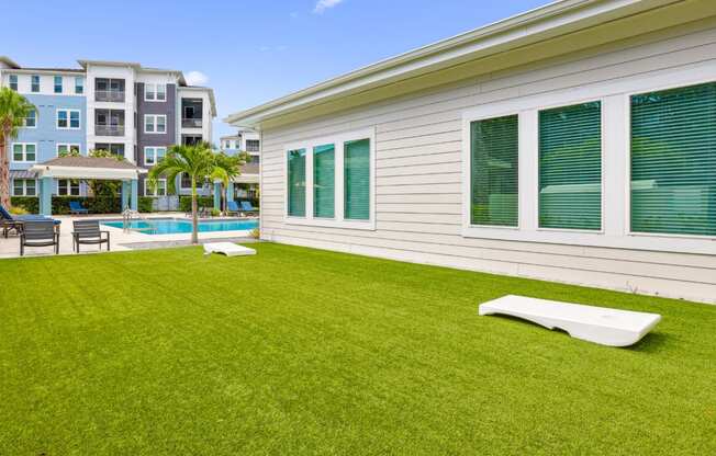 Corn hole boards by the pool at Dunedin Commons apartments in Dunedin, FL