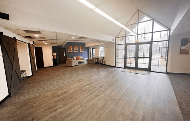 a large room with a wood floor and a large window