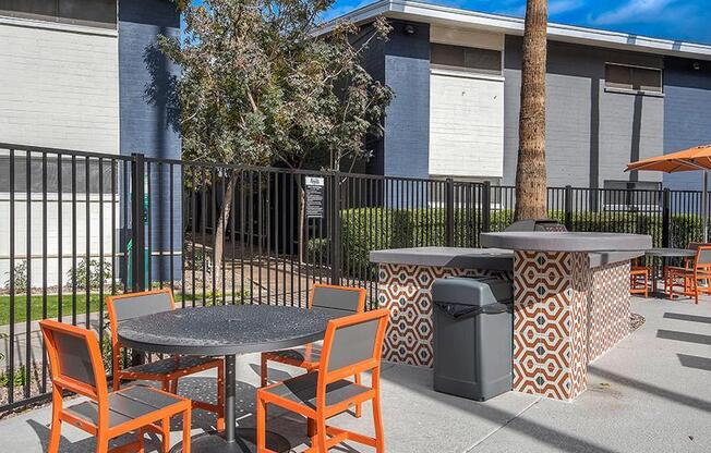 a patio with tables and chairs in front of a building