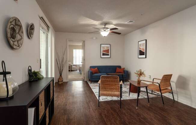 a living room with a couch and a table and a ceiling fan