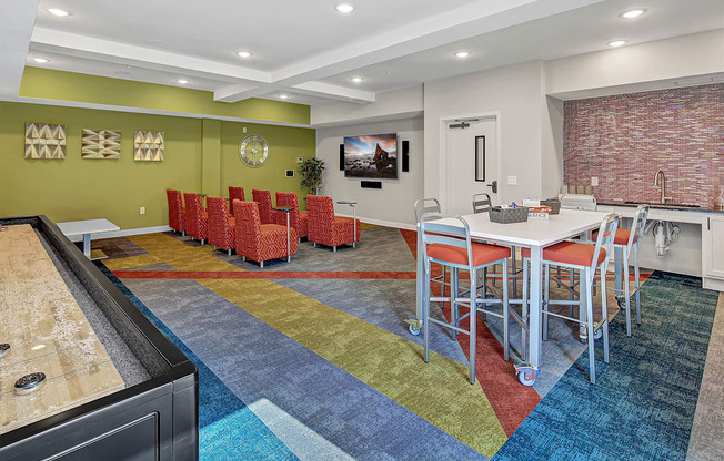 a community room with a table and chairs and a sink