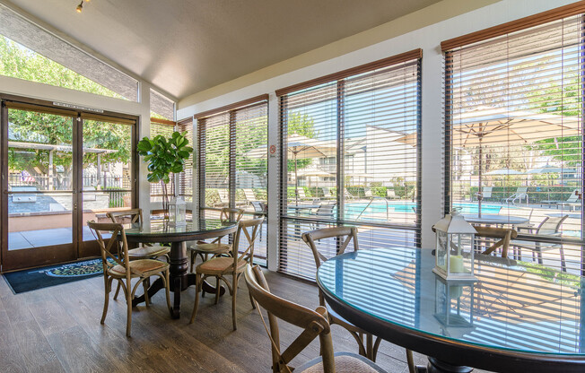 A dining room with a glass table and chairs.
