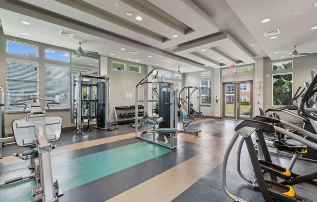 a gym with weights and cardio equipment at the estates at johnsons crossing