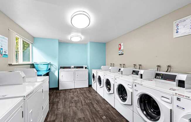 A row of washing machines in the onsite laundry facility