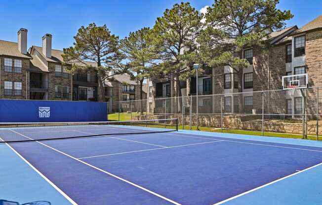 take a swing at one of the tennis courts at the enclave at woodbridge apartments in sugar