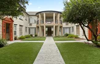 Van Nuys CA Apartments for Rent - Stunning Apartment Building Featuring Lush Green Landscaping and Large Courtyard