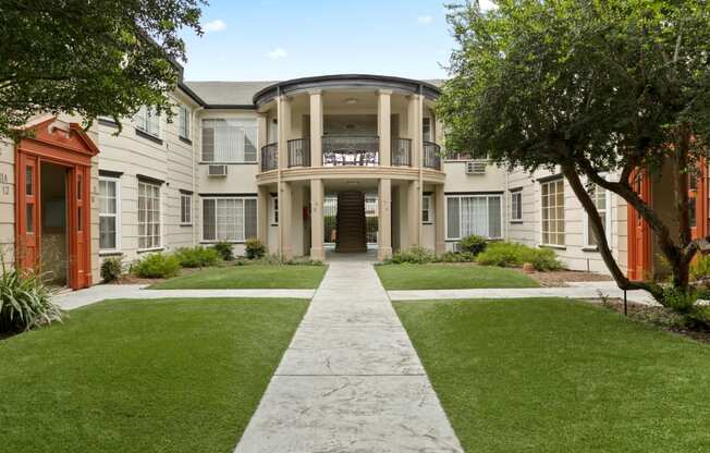 Van Nuys CA Apartments for Rent - Stunning Apartment Building Featuring Lush Green Landscaping and Large Courtyard