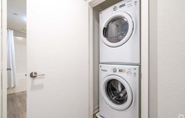 A white washing machine and dryer in a small laundry room.