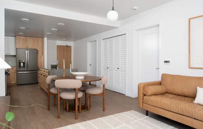 a living room and kitchen with a dining table and a couch at Slabtown Square Apartments, Oregon