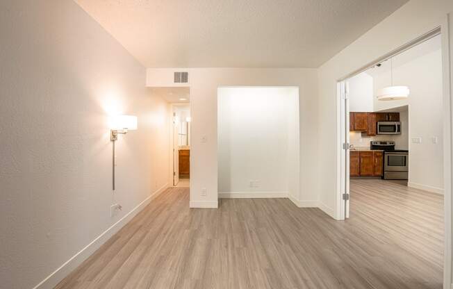 a bedroom with hardwood floors and white walls