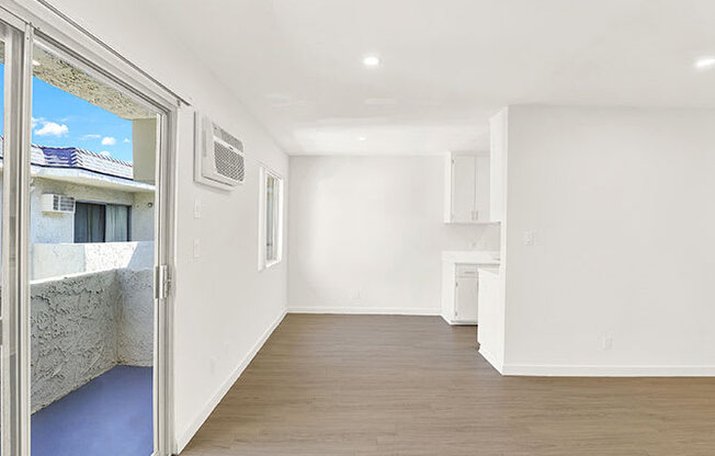 A room with a window and a door leading outside.