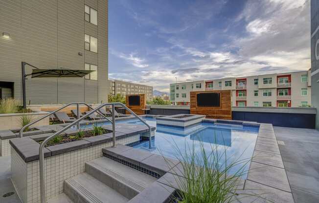 apartments with a pool and stairs in front of a building