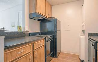 a kitchen with a refrigerator and a stove and a sink