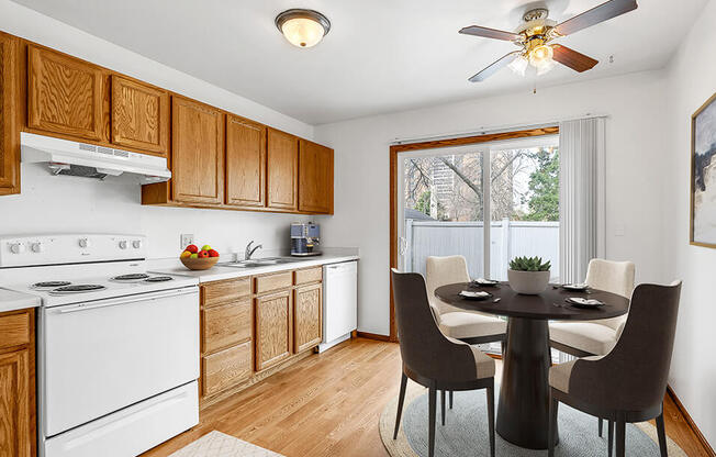 A kitchen with a table and chairs.