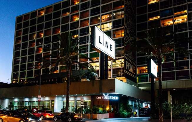 a city street with a large lit up sign in front of a building