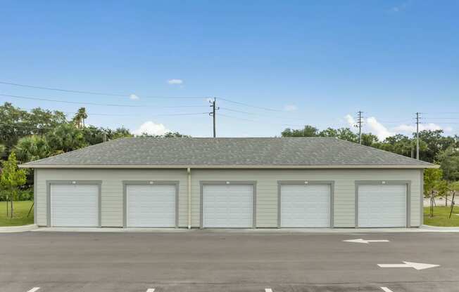 the front of a garage with white garage doors