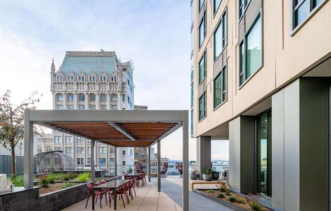 A modern building with a patio and a bench.