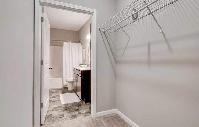 a bathroom with a shower and a sink and a toilet. Circle Pines, MN Lexington Lofts