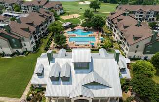 an aerial view of an apartment complex with a swimming pool