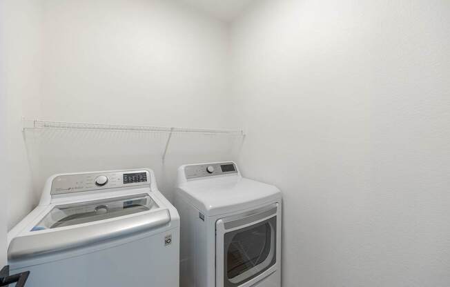 A white washing machine and dryer in a small laundry room.