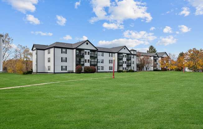 Apartment complex with a green lawn in front.