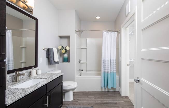 a bathroom with a toilet sink and bathtub in a 555 waverly unit