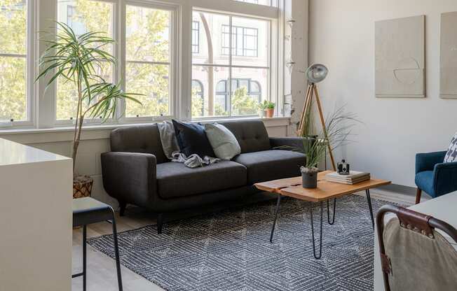 a living room with a large window and a couch at The 22 Apartments, St. Louis