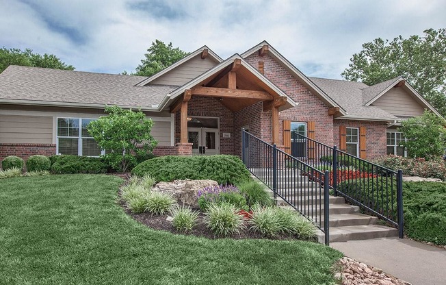 The leasing office & clubhouse with pretty landscaping at Preston Court Apartments in Overland Park, KS.