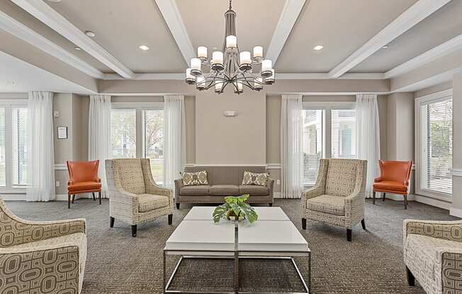 a living room with couches and chairs and a coffee table