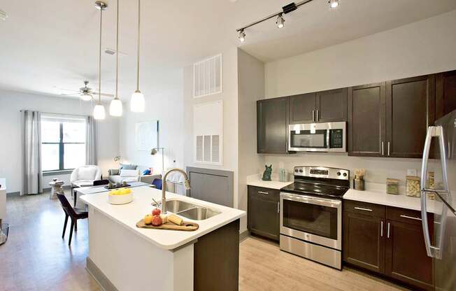 a kitchen with a large island and stainless steel appliances