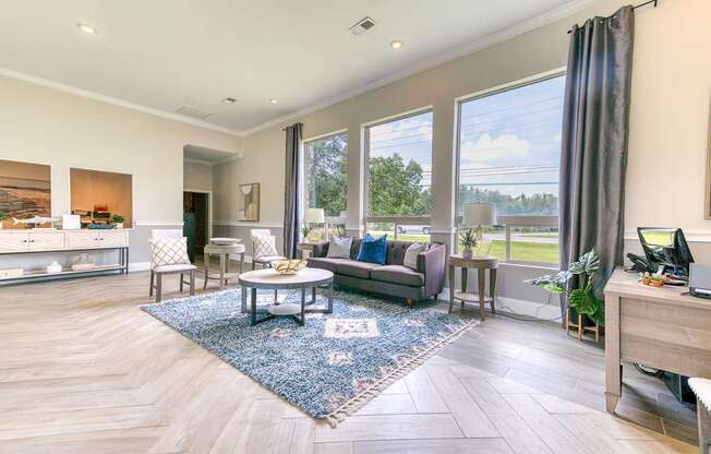 A spacious living room with a large window overlooking a green landscape.