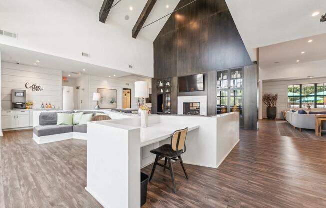 a kitchen with a large island and a living room with a fireplace