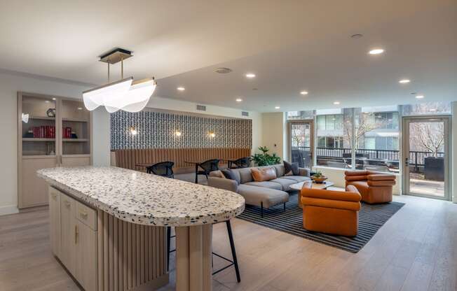 a clubhouse with a bar and a living room with couches