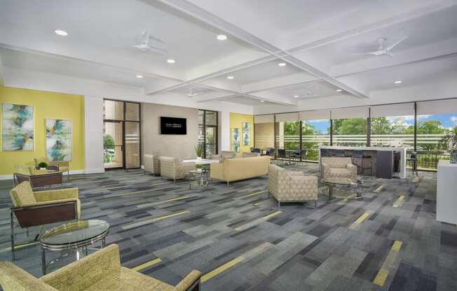 community space with gray carpeting and light green lounge chairs  at Seven Springs Apartments, College Park, MD