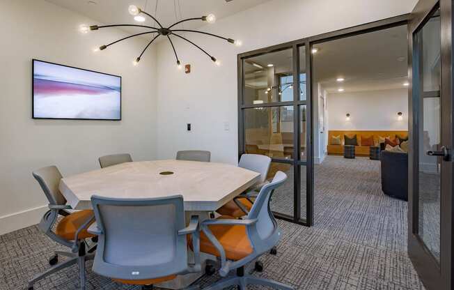 a view of a room with tables and chairs and a mirrored wall