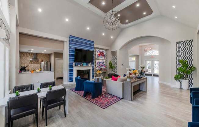 A living room with a fireplace and a dining table.