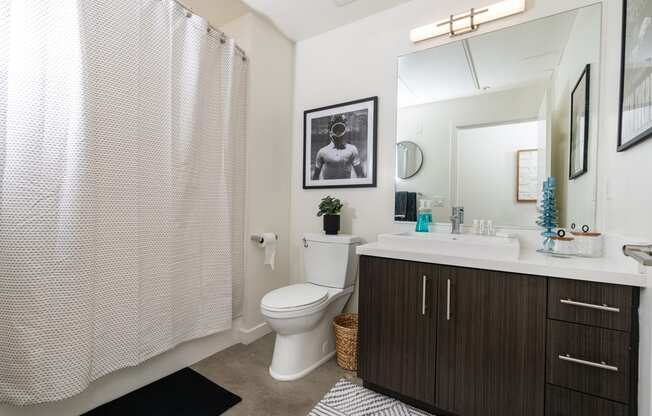 a bathroom with a shower and a toilet and a sink