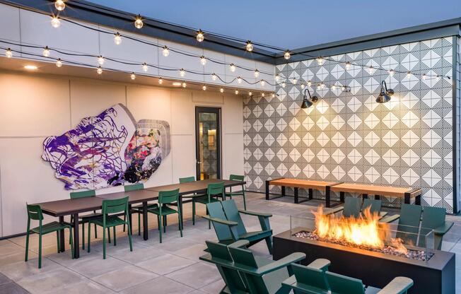 Unwind under the stars at Modera Woodstock's outdoor terrace, featuring a warm and inviting firetable.