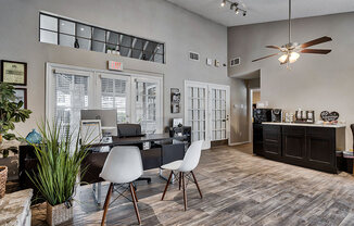 an office with a desk and chairs and a ceiling fan at The Broadwater at Salado Creek, San Antonio, Texas
