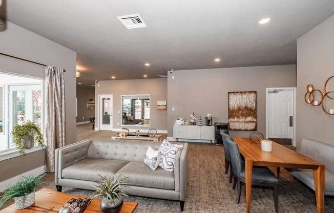 a living and dining room area with a couch table and chairs