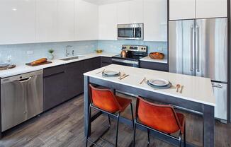 Modern eat-in kitchen with two tone cabinets and stainless appliances