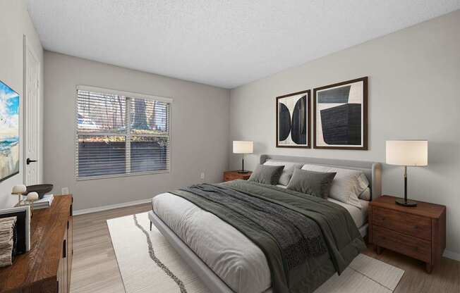 A bedroom with a large bed and two lamps.